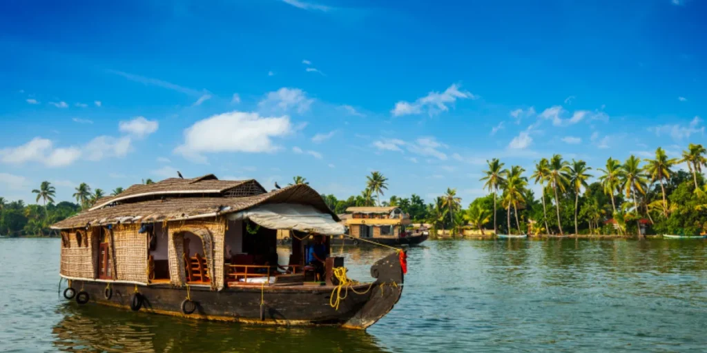 luxury houseboat sailing in Kerala backwaters under clear blue sky